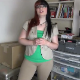 A plump, redheaded girl wearing glasses repeatedly farts into a cardboard box. Over 6 minutes.